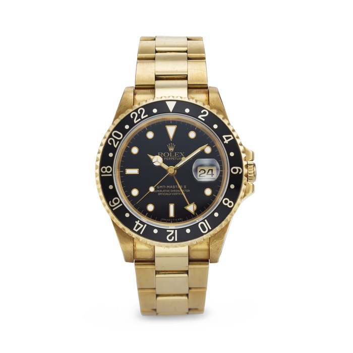 ROLEX. THE ONLY KNOWN AND HIGHLY ATTRACTIVE 18K GOLD AUTOMATIC DUAL TIME WRISTWATCH WITH SWEEP CENTER SECONDS, DATE AND BRACELET, RETAILED BY PATEK PHILIPPE SIGNED ROLEX, SOLD TO PATEK PHILIPPE, GMT-MASTER II MODEL, REF. 16718, CASE NO. N230318, CIRCA 1991