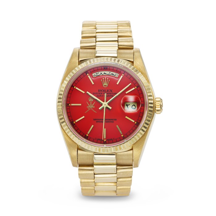 ROLEX. AN EXTREMELY RARE AND HIGHLY ATTRACTIVE 18K GOLD AUTOMATIC WRISTWATCH WITH SWEEP CENTER SECONDS, ARABIC CALENDAR, RED LACQUERED 'STELLA' DIAL AND BRACELET, MADE FOR THE SULTANATE OF OMAN SIGNED ROLEX, DAY-DATE MODEL, REF. 18038, CASE NO. 6'309'617, CIRCA 1979
