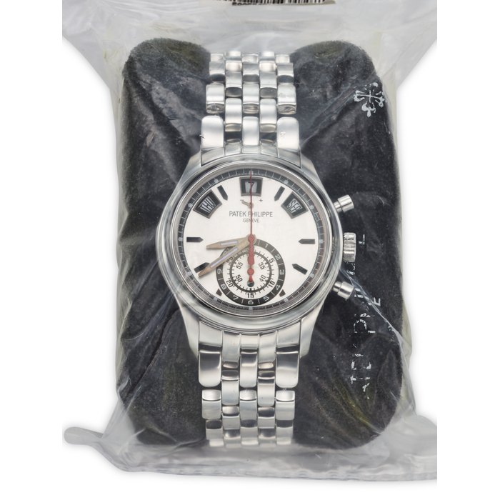PATEK PHILIPPE. A SPORTY AND FACTORY SEALED STAINLESS STEEL AUTOMATIC ANNUAL CALENDAR FLYBACK CHRONOGRAPH WRISTWATCH WITH POWER RESERVE, DAY/NIGHT INDICATOR AND BRACELET SIGNED PATEK PHILIPPE, REF. 5960/1A-001, CIRCA 2014