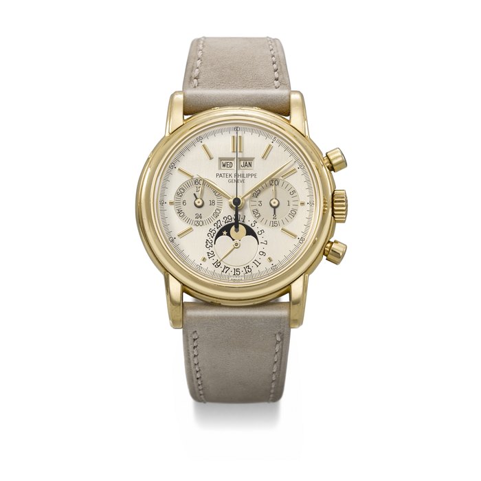 PATEK PHILIPPE. AN EXTREMELY RARE AND HIGHLY ATTRACTIVE 18K GOLD PERPETUAL CALENDAR CHRONOGRAPH WRISTWATCH WITH MOON PHASES, 24 HOUR INDICATION, LEAP YEAR INDICATION AND TWO-TONE DIAL SIGNED PATEK PHILIPPE, REF. 3970, FIRST SERIES, MOVEMENT NO. 875'015, CASE NO. 2'824'125, CIRCA 1986