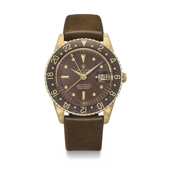 Rolex ROLEX. A VERY RARE AND HIGHLY ATTRACTIVE 18K GOLD AUTOMATIC DUAL TIME WRISTWATCH WITH SWEEP CENTRE SECONDS, DATE AND NO CROWN GUARDS SIGNED ROLEX, GMT-MASTER MODEL, REF. 1675, CASE NO. 900'039, CIRCA 1963 · 1675