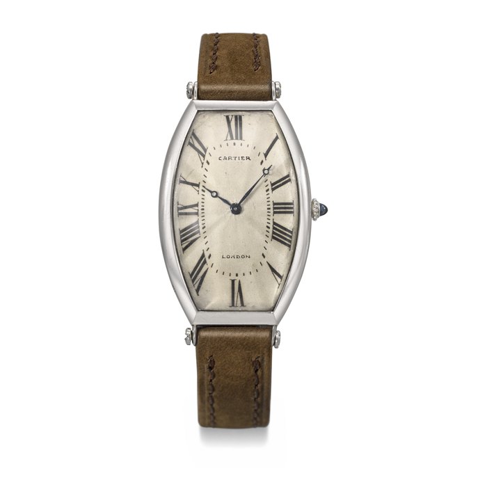 CARTIER. AN EXCEEDINGLY RARE AND EARLY PLATINUM AND 18K GOLD LARGE CURVED TONNEAU-SHAPED WRISTWATCH SIGNED CARTIER, TONNEAU CINTRÉE MODEL, CASE NOS. 4370, 7296, THE MOVEMENT SIGNED CARTIER PARIS, CIRCA 1912