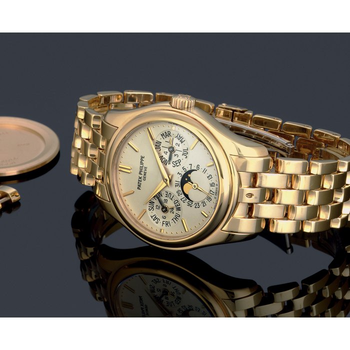 PATEK PHILIPPE. A FINE 18K GOLD AUTOMATIC PERPETUAL CALENDAR WRISTWATCH WITH PHASES OF THE MOON, BRACELET, ORIGINAL CERTIFICATE AND ADDITIONAL GOLD CASE BACK SIGNED PATEK PHILIPPE, GENEVE, MOVEMENT NO. 3127897, CASE NO. 4260766, REF. 5136/1J-001, CIRCA 2008