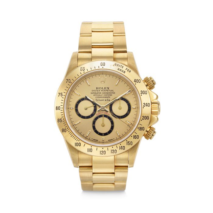 Rolex ROLEX. AN EXTREMELY RARE AND COVETED 18K GOLD AUTOMATIC CHRONOGRAPH WRISTWATCH WITH BRACELET, RETAILED BY TIFFANY & CO. DAYTONA ‘ZENITH’ MODEL, RETAILED BY TIFFANY & CO., REF. 16528, CASE NO. N195039, CIRCA 1991 · 16528