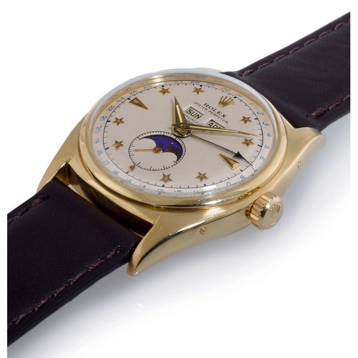 Rolex ROLEX. A FINE AND RARE 18K GOLD AUTOMATIC TRIPLE CALENDAR WRISTWATCH WITH STAR DIAL AND MOON PHASES SIGNED ROLEX, OYSTER PERPETUAL, CASE NO. 788591, REF. 6062, CIRCA 1952 · 6062