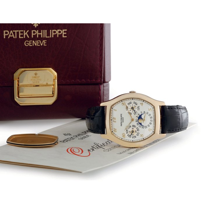 PATEK PHILIPPE. AN 18K GOLD TONNEAU AUTOMATIC PERPETUAL CALENDAR WRISTWATCH WITH MOON PHASES, CERTIFICATE, ADDITIONAL BACK AND BREQUET NUMERALS SIGNED PATEK PHILIPPE, GENEVE, MOVEMENT NO. 773884, CASE NO. 2923314, REF. 5040, MANUFACTURED IN 1993