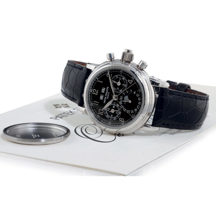 PATEK PHILIPPE. A FINE AND RARE PLATINUM PERPETUAL CALENDAR SPLIT SECONDS CHRONOGRAPH WRISTWATCH WITH MOON PHASES AND BLACK DIAL SIGNED PATEK PHILIPPE, GENEVE, MOVEMENT NO. 879727, CASE NO. 4034187, REF. 5004, MANUFACTURED IN 1998