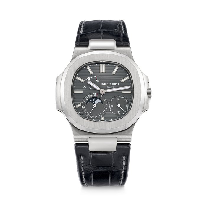 PATEK PHILIPPE. AN 18K WHITE GOLD AUTOMATIC WRISTWATCH WITH DATE, POWER RESERVE AND MOON PHASES NAUTILUS MODEL, REF. 5712G-001, MOVEMENT NO. 7’387’558, CASE NO. 6’461’777, CIRCA 2021
