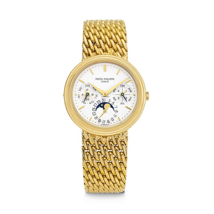 PATEK PHILIPPE. AN 18K GOLD AUTOMATIC PERPETUAL CALENDAR BRACELET WATCH WITH MOON PHASES, LEAP YEAR AND 24 HOUR INDICATIONS REF. 3945/001J, MOVEMENT NO. 772'041, CASE NO. 2'866'993, CIRCA 1990