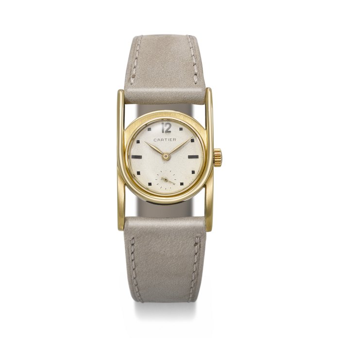 PATEK PHILIPPE. AN EXCEEDINGLY RARE AND UNUSUAL 18K GOLD CURVED WRISTWATCH WITH OVERSIZED LUGS THE DIAL SIGNED CARTIER, REF. 497, MOVEMENT NO. 825’378, CASE NO. 614’316, CARTIER NO. 808*, MANUFACTURED IN 1931