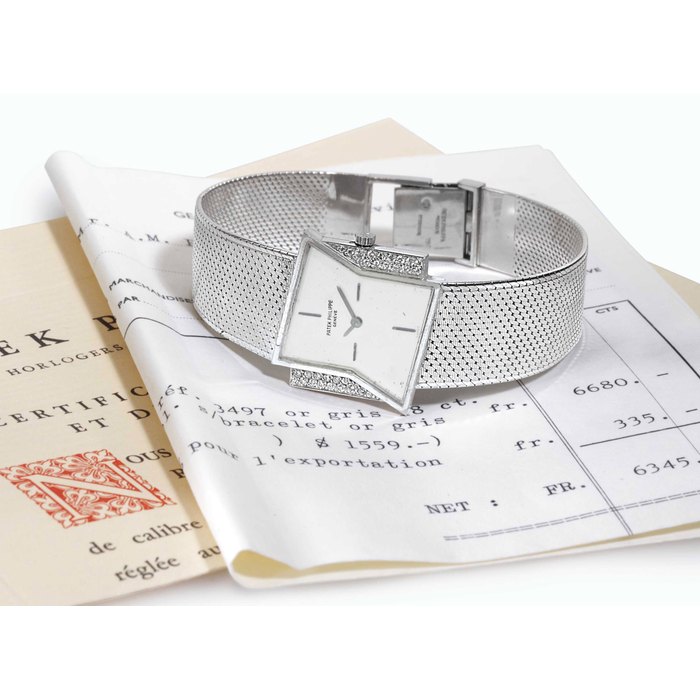 PATEK PHILIPPE. A RARE 18K WHITE GOLD AND DIAMOND ASYMMETRICAL WRISTWATCH WITH BRACELET, ORIGINAL CERTIFICATE OF ORIGIN AND PATEK PHILIPPE BILL OF SALE SIGNED PATEK PHILIPPE. MOVEMENT NO. 1160923, CASE NO. 2644167, REF. 3497, MANUFACTURED IN 1968