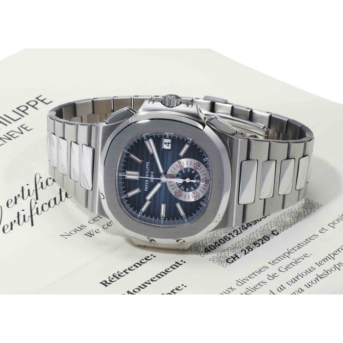 Patek Philippe. A Fine Stainless Steel Automatic Chronograph Wristwatch With Date, Bracelet And Original Certificate SIGNED PATEK PHILIPPE, GENEVA, NAUTILUS MODEL, REF. 5980, MOVEMENT NO. 4'040'612, CASE NO. 4'490'698, CIRCA 2009