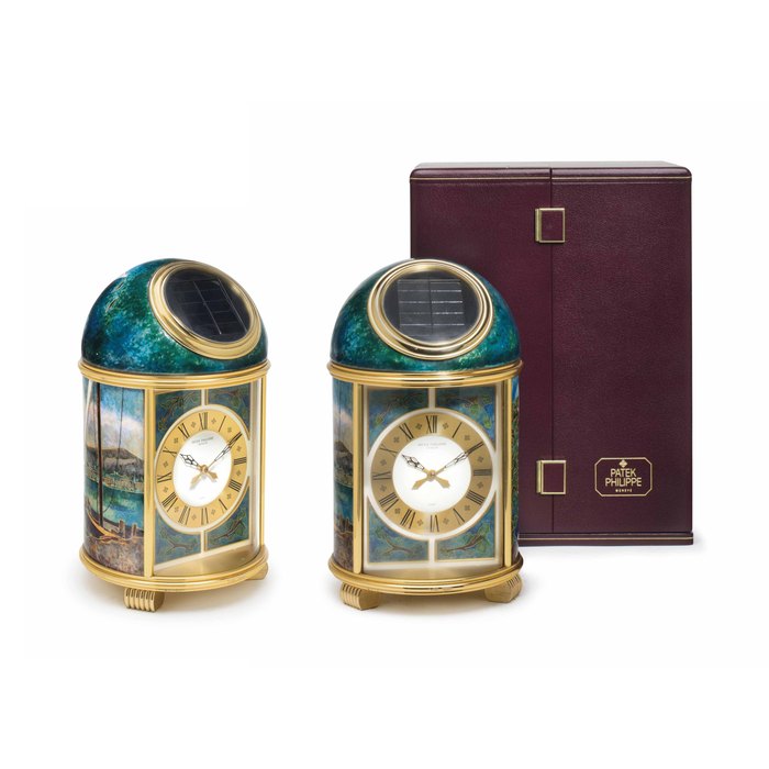 Patek Philippe. A Fine and Unique Gilt Brass Solar-Powered Desk Clock with Cloisonné Sail Boat Motif and Original Presentation Box SIGNED PATEK PHILIPPE, GENEVA, PENDULETTE DOME MODEL, BARQUE ET LE SALÈVE , REF. 1328, MOVEMENT NO. 1'803'814, CASE NO. 31'498, MANUFACTURED IN 1988