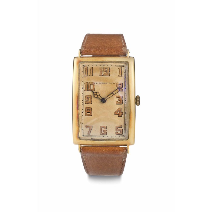 Patek Philippe. An 18k Gold Curved Rectangular Wristwatch SIGNED PATEK PHILIPPE, RETAILED BY TIFFANY & CO., MOVEMENT NO. 184'094, CASE NO. 291'038, MANUFACTURED IN 1920