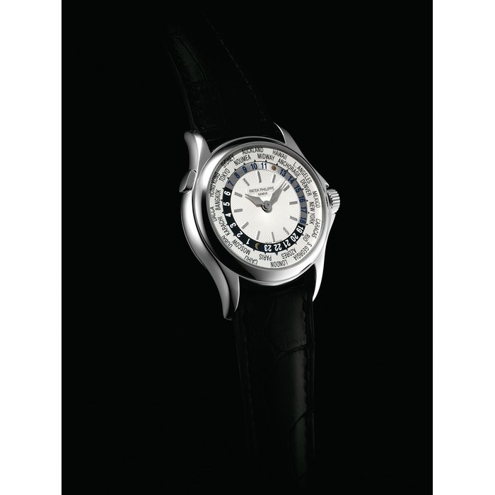 PATEK PHILIPPE. A FINE 18K WHITE GOLD AUTOMATIC WORLD TIME WRISTWATCH SIGNED PATEK PHILIPPE, GENEVE, REF. 5110, MOVEMENT NO. 3'213'383, CASE NO. 4'180'957, CIRCA 2005