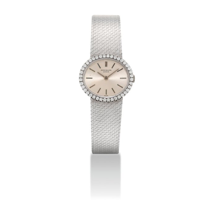 PATEK PHILIPPE. A LADY'S FINE 18K WHITE GOLD AND DIAMOND-SET OVAL BRACELET WATCH SIGNED PATEK PHILIPPE, GENEVE, REF. 3350/1, MOVEMENT NO. 990'596, CASE NO. 2'678'165, MANUFACTURED IN 1969