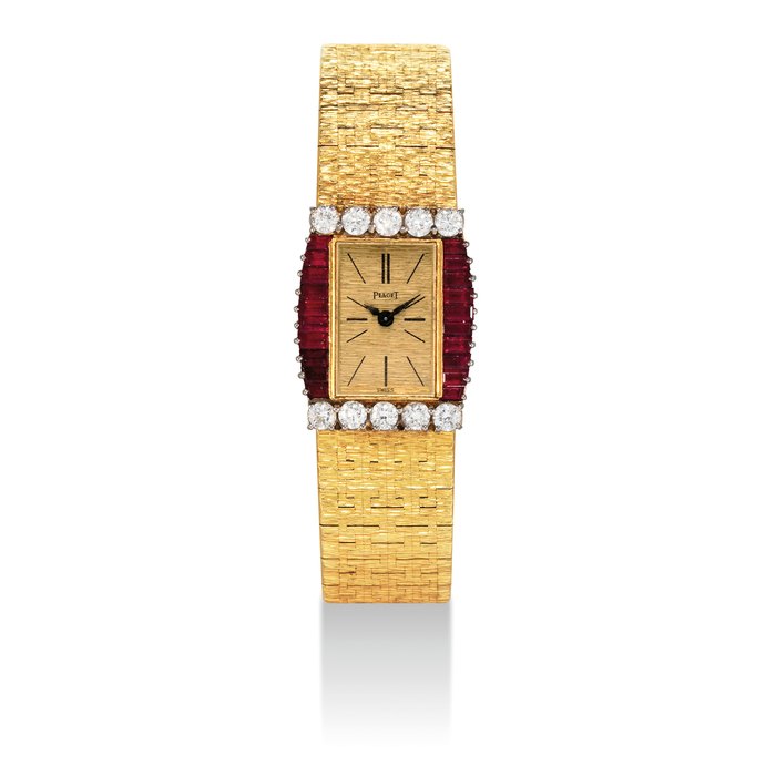 PIAGET. A LADY'S 18K GOLD, RUBY AND DIAMOND-SET RECTANGULAR BRACELET WATCH SIGNED PIAGET, REF. 3876 A6, CASE NO. 167'166, CIRCA 1980