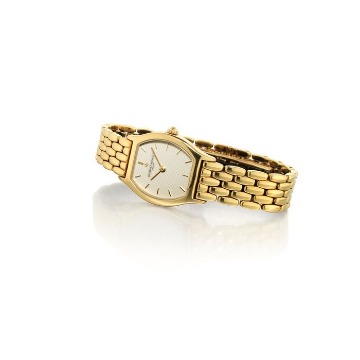 Vacheron Constantin VACHERON CONSTANTIN. A LADY'S 18K GOLD TONNEAU-SHAPED WRISTWATCH WITH BRACELET SIGNED VACHERON CONSTANTIN, GENEVE, MOVEMENT NO. 834'970, CASE NO. 653'504, CIRCA 2000