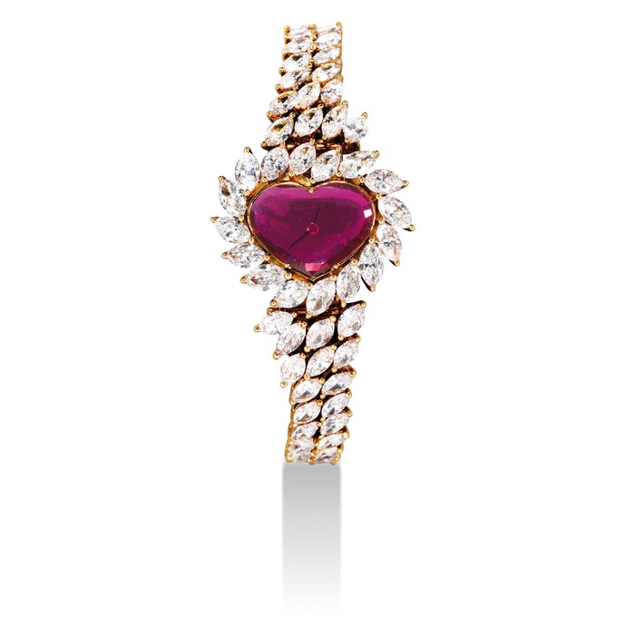 GERALD GENTA. A LADY'S FINE, VERY RARE AND UNIQUE 18K GOLD, DIAMOND AND RUBY-SET HEART-SHAPED BRACELET WATCH SIGNED GERALD GENTA, REF. G3034YG, CASE NO. N48757, CIRCA 2003