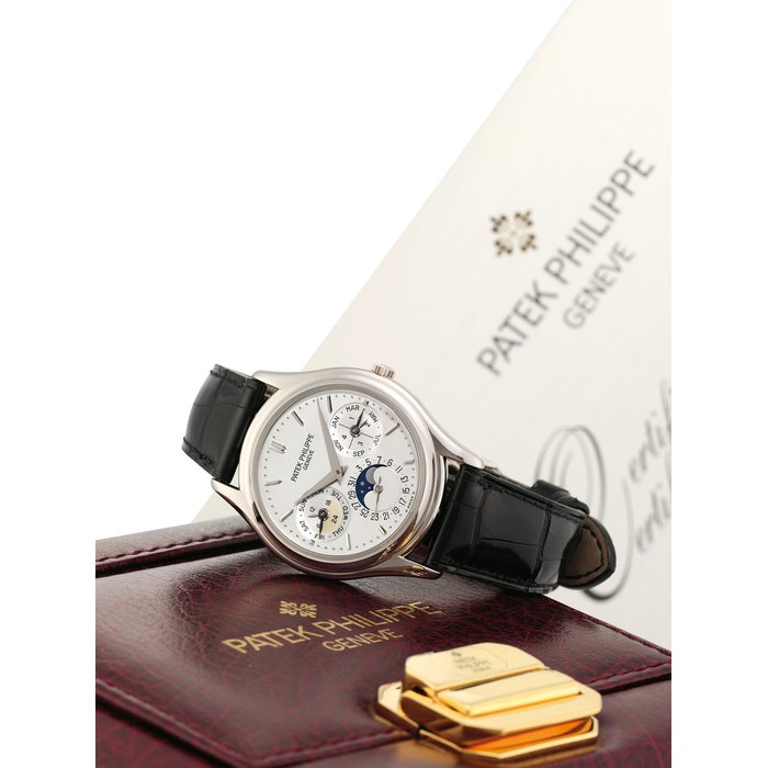 PATEK PHILIPPE. A FINE AND RARE 18K WHITE GOLD AUTOMATIC PERPETUAL CALENDAR WRISTWATCH WITH MOON PHASES, 24 HOUR, LEAP YEAR INDICATION, ORIGINAL CERTIFICATE, ADDITIONAL CASE BACK AND BOX SIGNED PATEK PHILIPPE, GENEVE, REF. 3940, MOVEMENT NO. 3'128'273, CASE NO. 4'315'978, CIRCA 2006