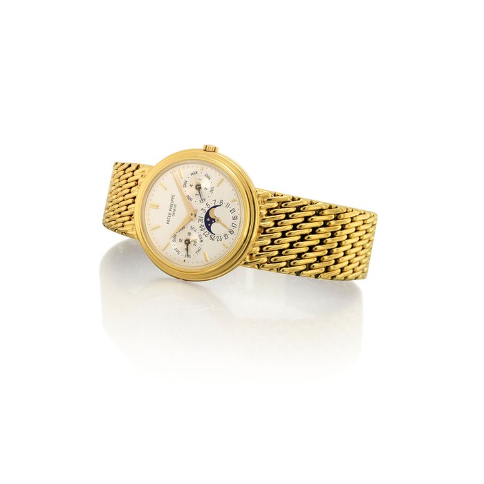 PATEK PHILIPPE. A FINE 18K GOLD AUTOMATIC PERPETUAL CALENDAR BRACELET WATCH WITH MOON PHASES, 24 HOUR AND LEAP YEAR INDICATION SIGNED PATEK PHILIPPE, GENEVE, REF. 3945/1, MOVEMENT NO. 770'847, CASE NO. 2'838'722, MANUFACTURED IN 1987