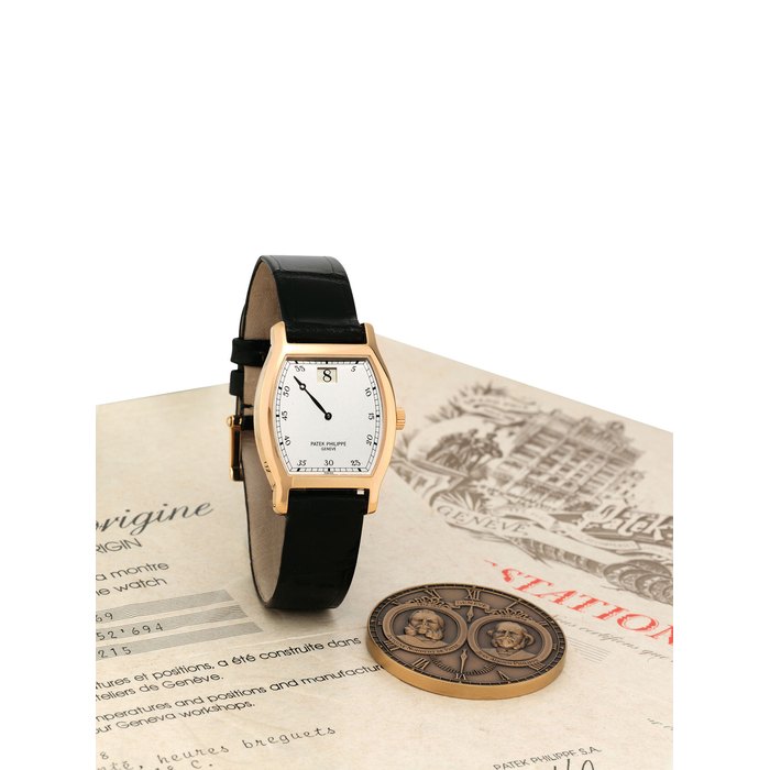 PATEK PHILIPPE. A VERY FINE AND RARE 18K PINK GOLD LIMITED EDITION TONNEAU-SHAPED JUMP HOUR WRISTWATCH WITH ORIGINAL CERTIFICATE, COMMEMORATIVE MEDAL AND BOX, MADE TO COMMEMORATE PATEK PHILIPPE'S 150TH ANNIVERSARY SIGNED PATEK PHILIPPE, GENEVE, JUMP HOUR MODEL, REF. 3969, MOVEMENT NO. 752'694, CASE NO. 2'864'607, CIRCA 1989