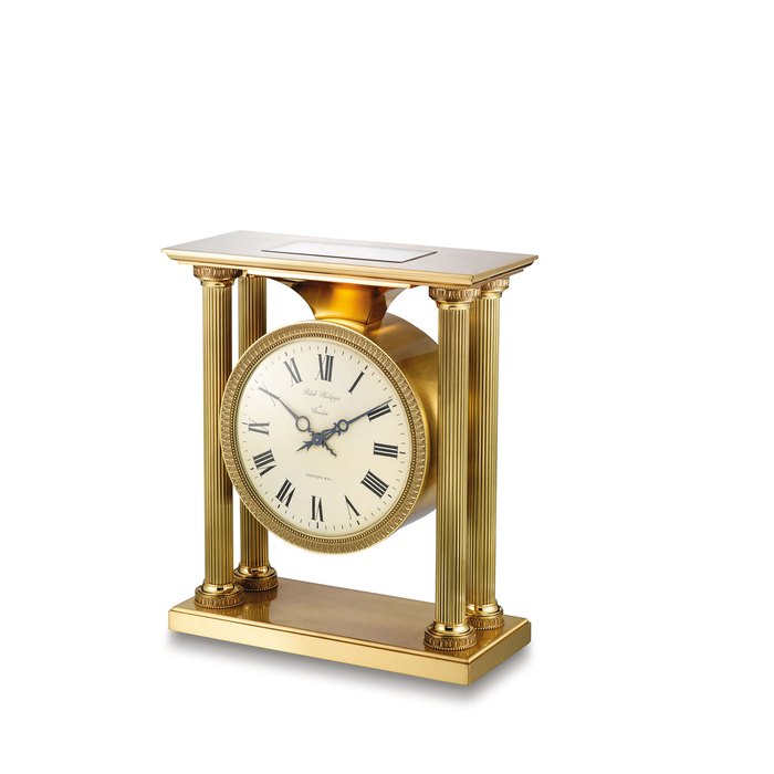 PATEK PHILIPPE. A HEAVY AND RARE GILT BRASS SOLAR-POWERED DESK CLOCK IN EMPIRE STYLE SIGNED PATEK PHILIPPE, À GENÈVE, RETAILED BY TIFFANY & CO., REF. 810, MOVEMENT NO. 873'897, CASE NO. 1504, MANUFACTURED IN 1966