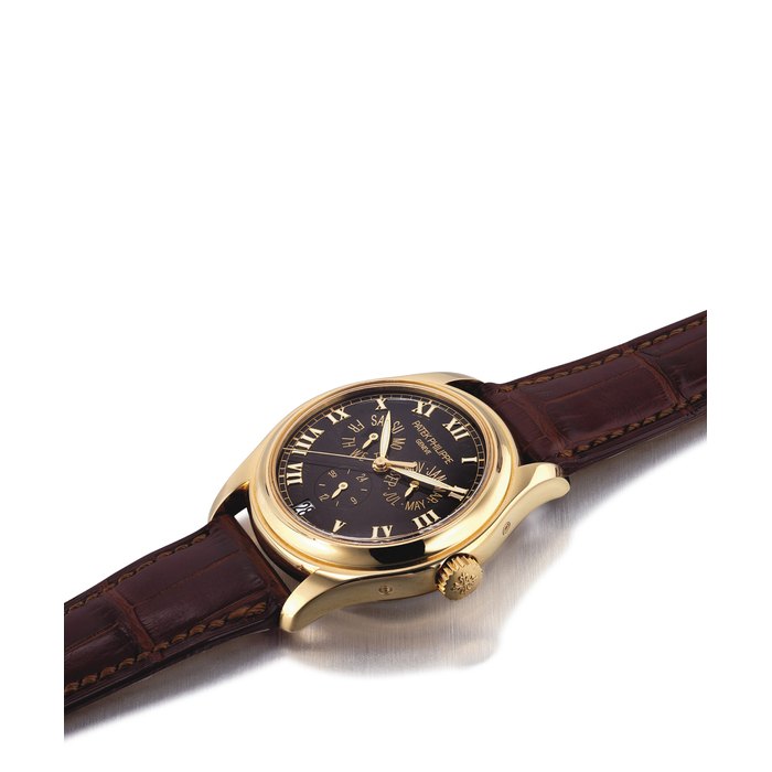 PATEK PHILIPPE. A FINE 18K GOLD AUTOMATIC ANNUAL CALENDAR WRISTWATCH WITH SWEEP CENTRE SECONDS, 24 HOUR INDICATION, BLACK DIAL, ORIGINAL CERTIFICATE AND BOX SIGNED PATEK PHILIPPE, GENEVE, REF. 5035, MOVEMENT NO. 3'137'083, CASE NO. 4'262'921, CIRCA 2005