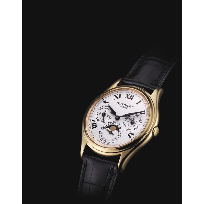 PATEK PHILIPPE. A FINE AND VERY RARE 18K GOLD AUTOMATIC PERPETUAL CALENDAR WRISTWATCH WITH MOON PHASES, 24 HOUR AND LEAP YEAR INDICATION, ROMAN NUMERALS, ORIGINAL CERTIFICATE AND BOX SIGNED PATEK PHILIPPE, GENEVE, REF. 3940, MOVEMENT NO. 3'125'853, CASE NO. 4'206'606, CIRCA 2004