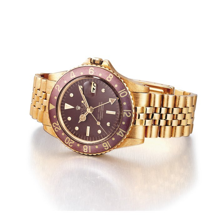 Rolex ROLEX. A FINE AND RARE 18K GOLD AUTOMATIC DUAL TIME WRISTWATCH WITH SWEEP CENTRE SECONDS, DATE, HACK FEATURE, BRACELET AND NIPPLE DIAL SIGNED ROLEX, OYSTER PERPETUAL, GMT-MASTER, REF. 1675, CASE NO. 5'903'947, CIRCA 1977 · 1675