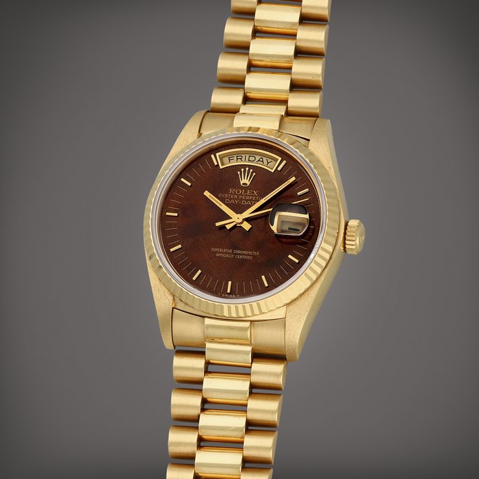 Rolex Day-Date, Reference 18038 | A yellow gold wristwatch with day, date, burl wood dial and bracelet | Circa 1979