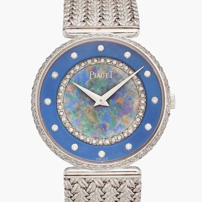 Piaget Reference 9027 D4X | A white gold and diamond-set bracelet watch with opal dial, Circa 1986
