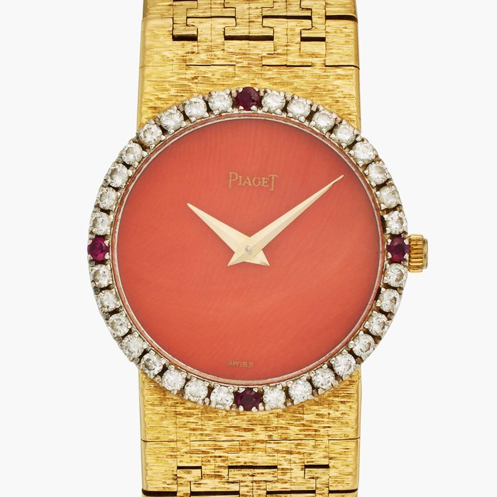 Piaget Reference 9706 A 6 | A yellow gold, ruby and diamond-set bracelet watch with coral dial, Circa 1970