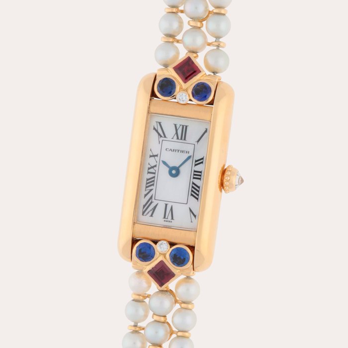 Cartier Tank Allongée, Reference 13801 | A yellow gold, pearl, ruby, sapphire and diamond-set bracelet watch with mother-of-pearl dial | Circa 1985