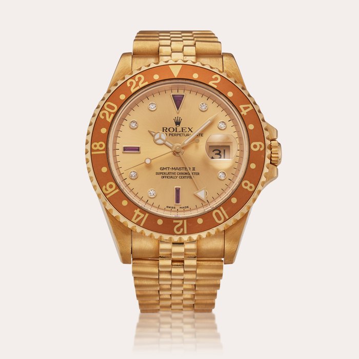 Rolex Reference 16718 GMT-Master II 'Rootbeer' | A yellow gold, ruby and diamond-set automatic dual-time zone wristwatch with date, bracelet and Serti dial, Circa 2005