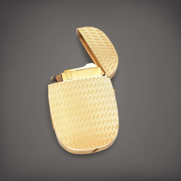 Patek Philippe Golden Ellipse 'Chevrons', Reference 9505 | A yellow gold and blue enamel lighter | Circa 1978
