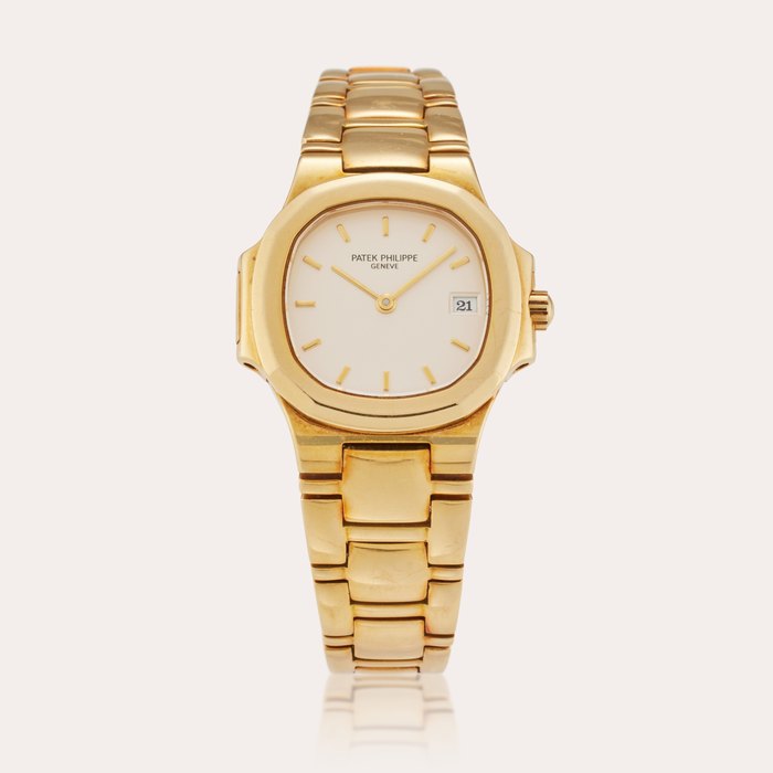 Patek Philippe Reference 4700/51 Nautilus | A yellow gold wristwatch with date and bracelet, Circa 1990