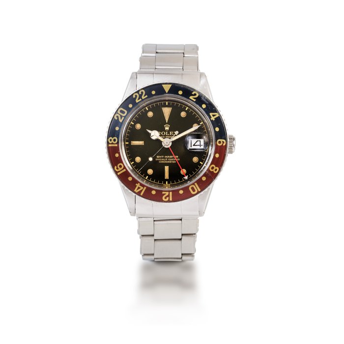Rolex 'Pussy Galore' GMT-Master, Ref. 6542    Montre bracelet en acier avec deux fuseaux horaires, date et lunette Bakélite |  Stainless steel dual time zone wristwatch with date, bracelet and Bakelite bezel    Vers 1959 |  Circa 1959, Price & Market Data
