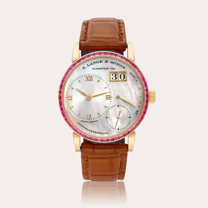 A. Lange & Söhne Little Lange 1 Soirée, Reference 813.031 | A pink gold and pink sapphire-set wristwatch with date, power reserve indication and mother-of-pearl dial, Circa 2000 | 朗格 | Little Lange 1 Soirée 型號813.031 | 粉紅金鑲粉紅色藍寶石腕錶，備日期、動力儲備顯示及珠母貝錶盤，約2000年製 · 813.031