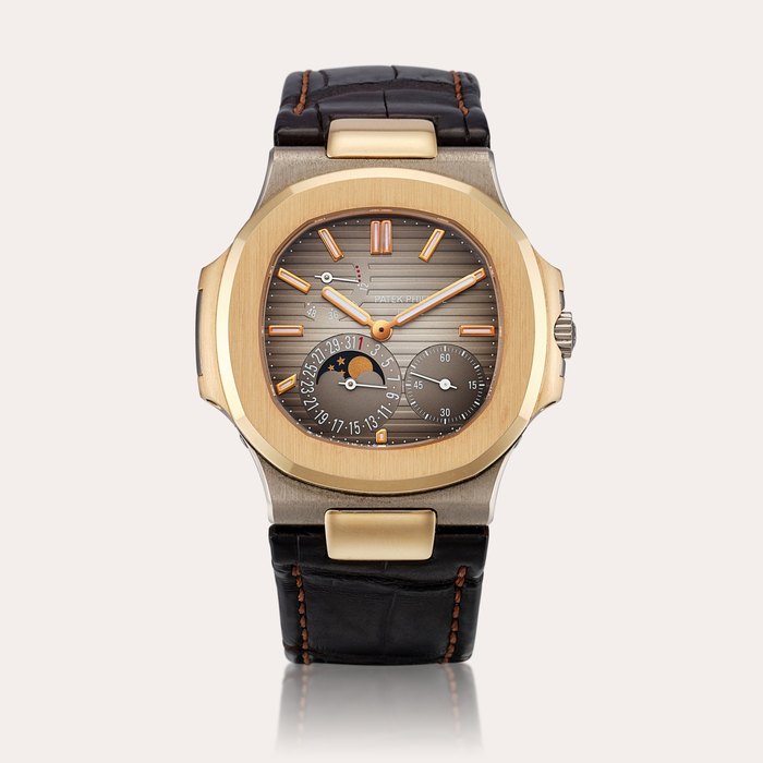 Patek Philippe Nautilus, Reference 5712 | A white and pink gold wristwatch with date, moon phases and power reserve indication, Made for the Hong Kong market, Circa 2010 | 百達翡麗 | Nautilus 型號5712 | 白金及粉紅金腕錶，備日期、月相及動力儲備顯示，為香港市場而製，約2010年製 · 5712