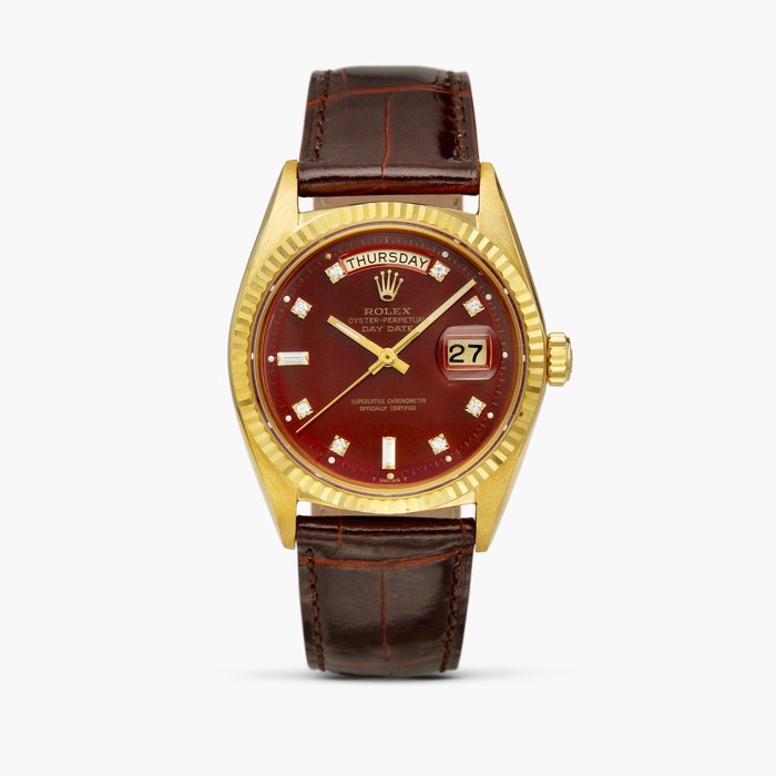 Rolex Day-Date "Stella", Reference 1803 | A yellow gold and diamond-set wristwatch with day, date and oxblood dial, Circa 1968, Price & Market Data