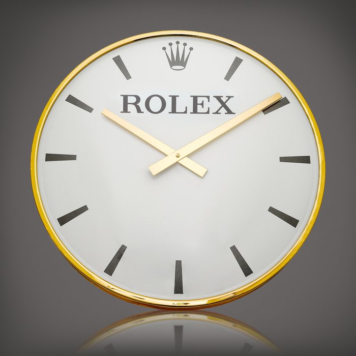 Rolex A gilt brass wall clock, Circa 1960 | 勞力士 | 鍍金銅製掛牆鐘，約1960年製