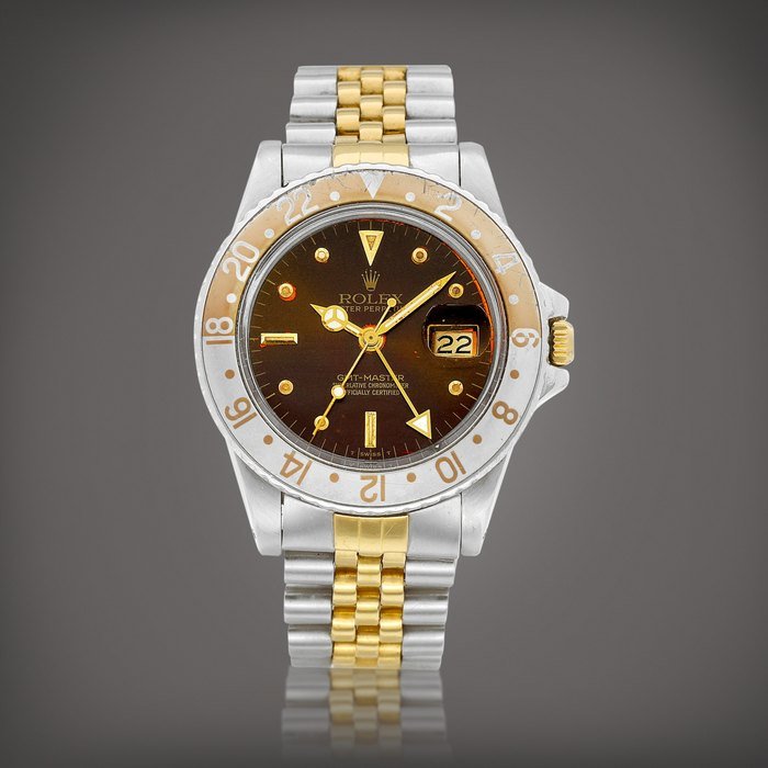 Rolex GMT-Master 'Root Beer', Reference 16753 | A yellow gold and stainless steel dual time zone wristwatch with date, tropical "nipple" dial and bracelet, Circa 1983 | 勞力士 | GMT-Master 'Root Beer' 型號16753 | 黃金及精鋼兩地時間鏈帶腕錶，備日期顯示及棕式錶盤，約1983年製 · 16753