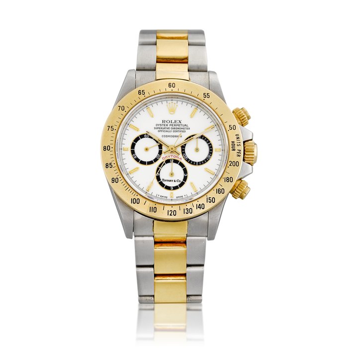Rolex Cosmograph Daytona, Reference 16523 | A yellow gold and stainless steel chronograph wristwatch with porcelain dial, suspended logo and bracelet, Retailed by Tiffany & Co., Circa 1988 | 勞力士 | Cosmograph Daytona 型號16520 | 黃金及精鋼計時鏈帶腕錶，備 porcelain 錶盤及懸浮標誌，由 Tiffany & Co. 發行，約1988年製 · 16523