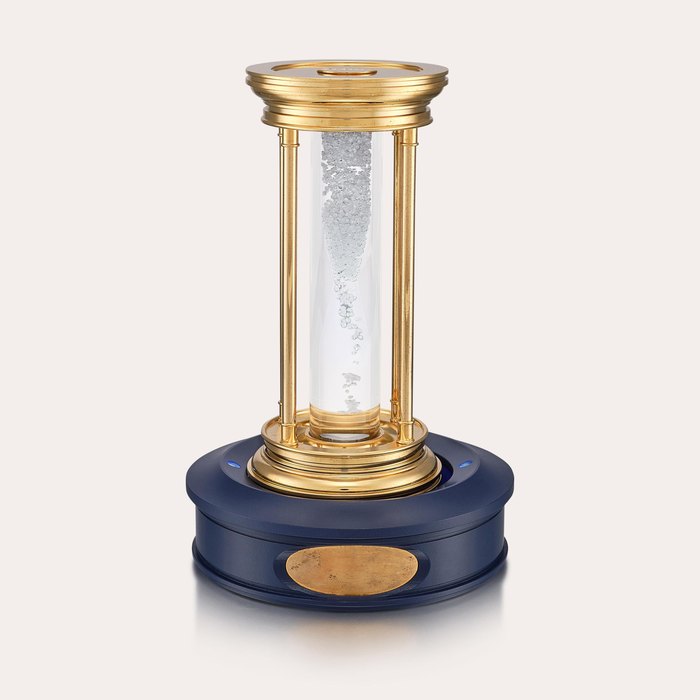 De Beers A limited edition gilt brass hourglass with floating diamonds, Circa 2000