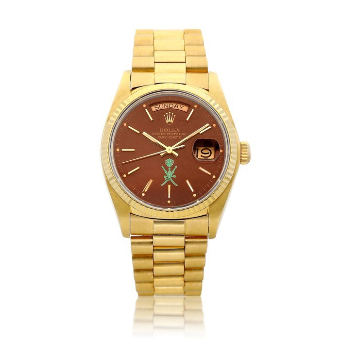 Rolex Day-Date, Reference 18038, A yellow gold wristwatch with day, date, bracelet, oxblood "Stella" dial and later green stamp, Circa 1980 Day-Date | 勞力士 型號18038 黃金鏈帶腕錶，備日期、星期顯示及牛血紅 "Stella" 錶盤及後期綠色印記，約1980年製 · 18038