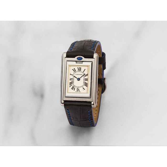 Cartier. Insolite montre bracelet de dame en acier rectangulaire reversible mouvement quartz Cartier. An unusual lady's stainless steel quartz reversible rectangular wristwatch Tank Basculante, Ref: 2386, Circa 2000