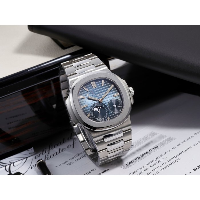 PATEK PHILIPPE | NAUTILUS, REF.5712/1A, A STAINLESS STEEL BRACELET WATCH WITH DATE, MOON PHASES AND POWER RESERVE INDICATOR, CIRCA 2012