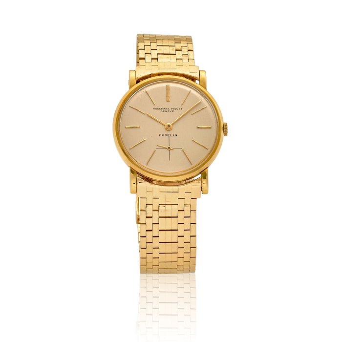 AUDEMARS PIGUET. AN 18K GOLD MANUAL WIND BRACELET WATCH RETAILED BY GÜBELINc.1950s