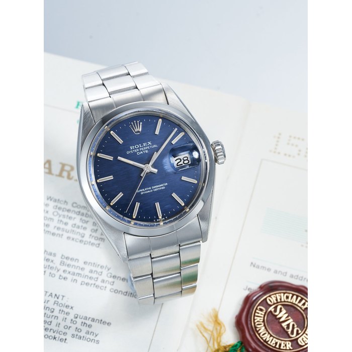 ROLEX | OYSTER PERPETUAL DATE, REF.1500, A RARE STAINLESS STEEL BRACELET WATCH WITH BLUE MOSAIC DIAL AND DATE, CIRCA 1971